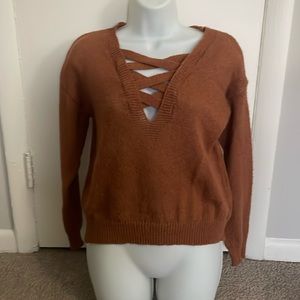 Burnt orange sweater with crisscross neckline